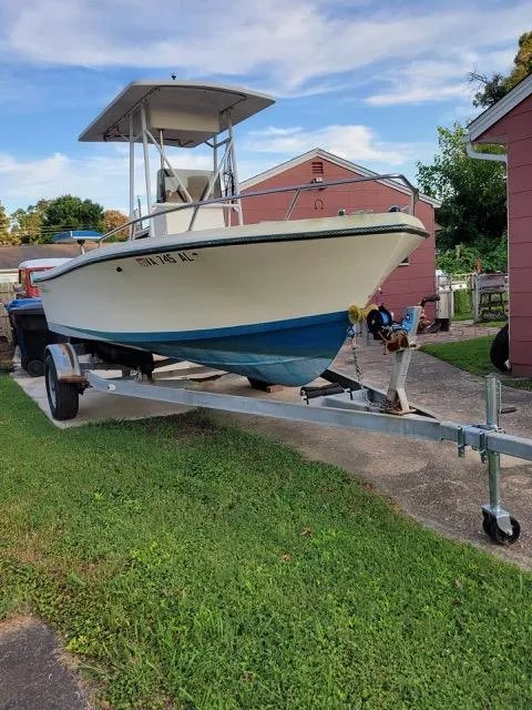 The Image of 1995 KenCraft Challenger 190 boat on trailer, parked in driveway, with blue and white hull. - 2