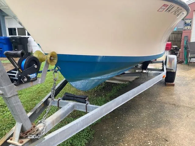 Slide: The Image of 1995 KenCraft Challenger 190 boat on trailer, blue hull, parked outdoors. - 6