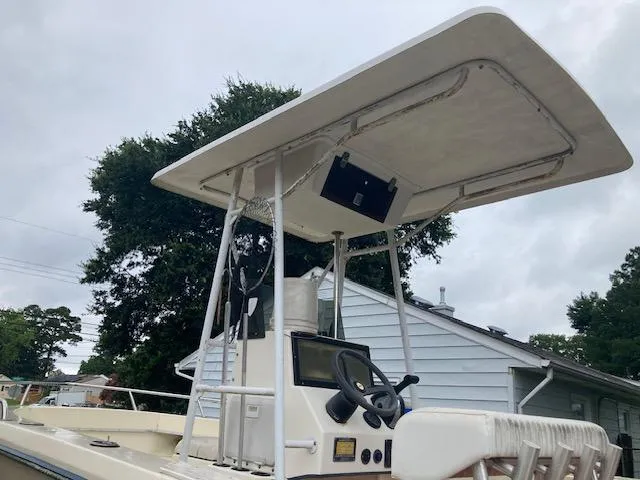 Slide: The Image of 1995 KenCraft Challenger 190 boat with T-top and steering console, parked outdoors. - 8