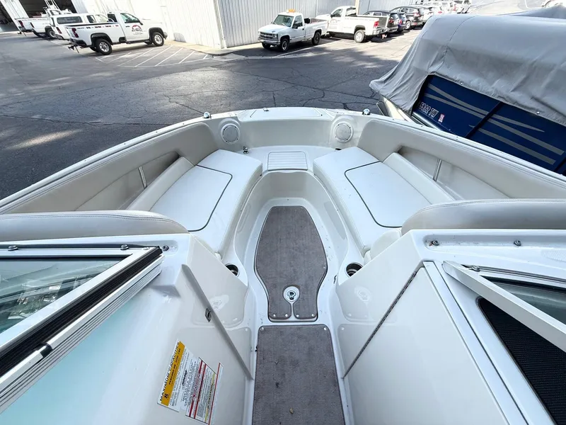 Slide: The Image of 2010 Sea Ray 220 Sundeck interior with white seating and carpeted floor. - 11