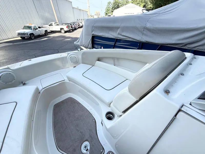 Slide: The Image of 2010 Sea Ray 220 Sundeck interior with white seating and carpeted floor. - 13