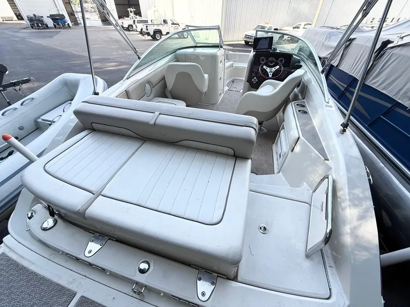 Slide: The Image of 2010 Sea Ray 220 Sundeck boat interior with seating and steering console. - 5