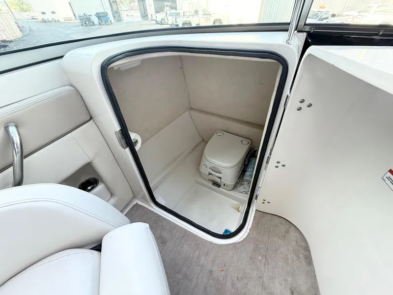 Slide: The Image of 2010 Sea Ray 220 Sundeck boat interior with compact toilet compartment. - 9