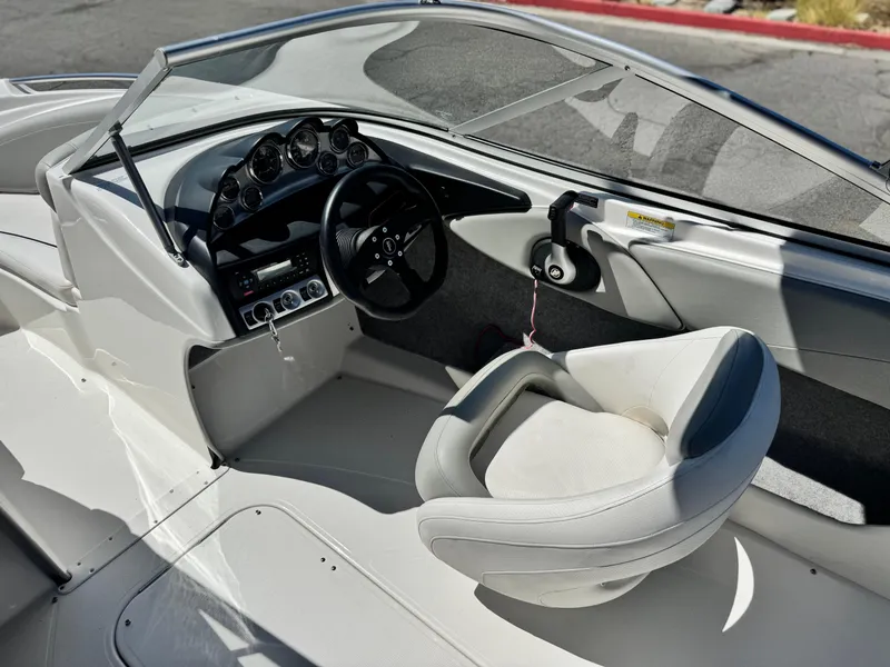 Slide: The Image of 2012 Bayliner 215 boat interior with steering wheel and dashboard controls. - 20
