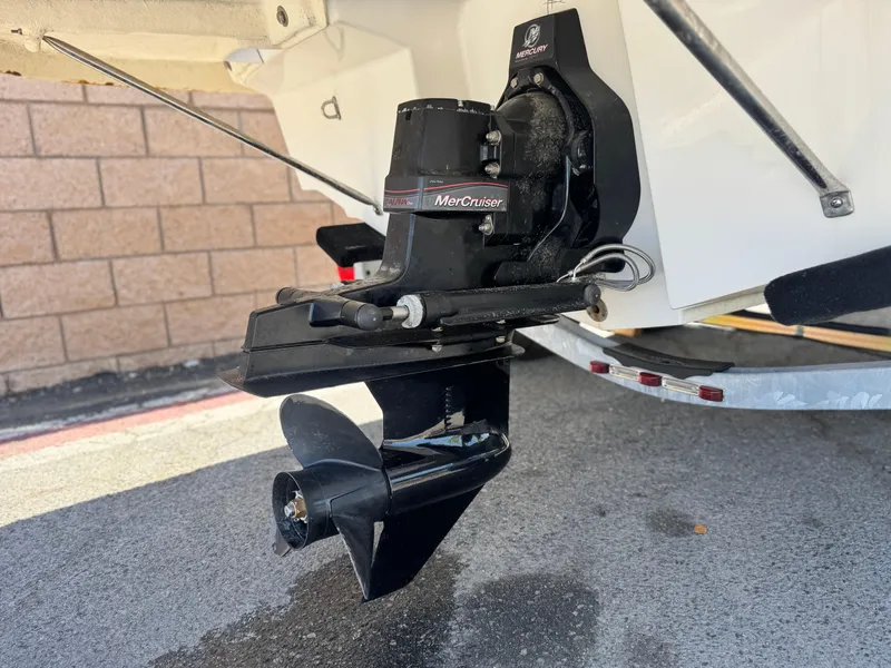 Slide: The Image of 2012 Bayliner 215 boat with MerCruiser outdrive, parked on a trailer. - 7