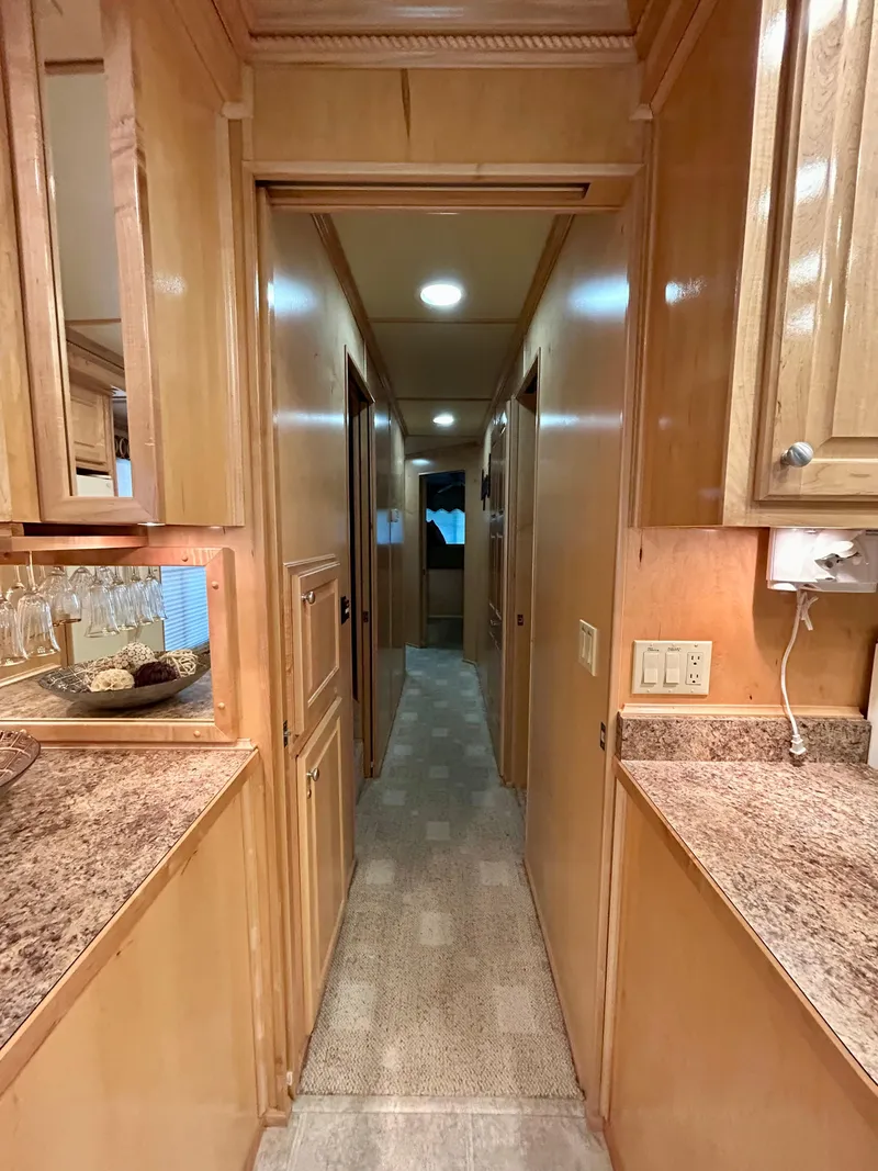 Slide: The Image of Interior hallway of a 2004 Horizon houseboat with wooden cabinetry and granite countertops. - 10