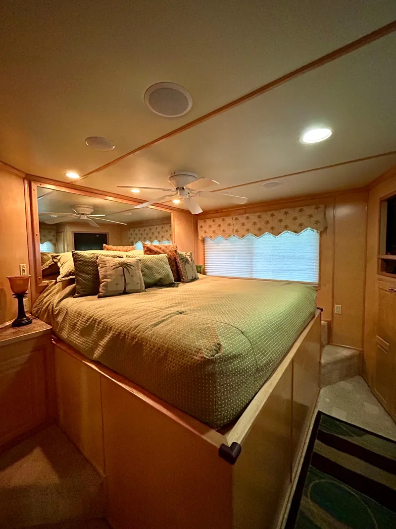 Slide: The Image of Luxurious bedroom interior of a 2004 Horizon houseboat with cozy bedding and ambient lighting. - 16