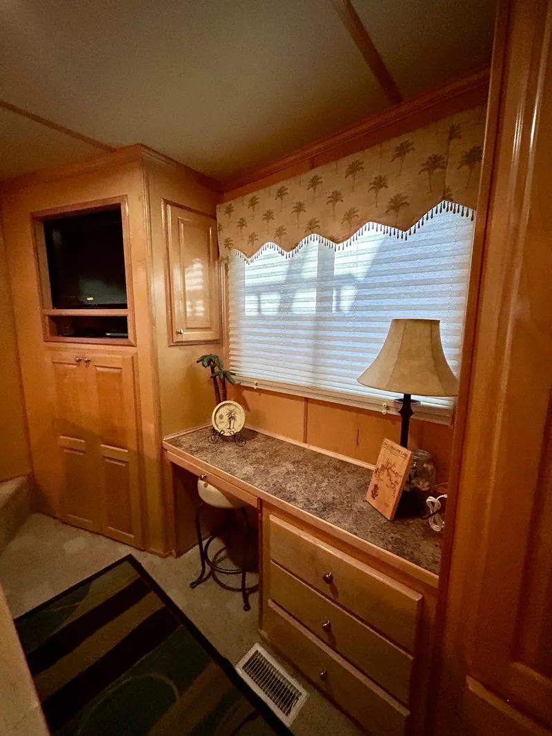 Slide: The Image of Interior of 2004 Horizon houseboat with desk, lamp, and decorative elements. - 17