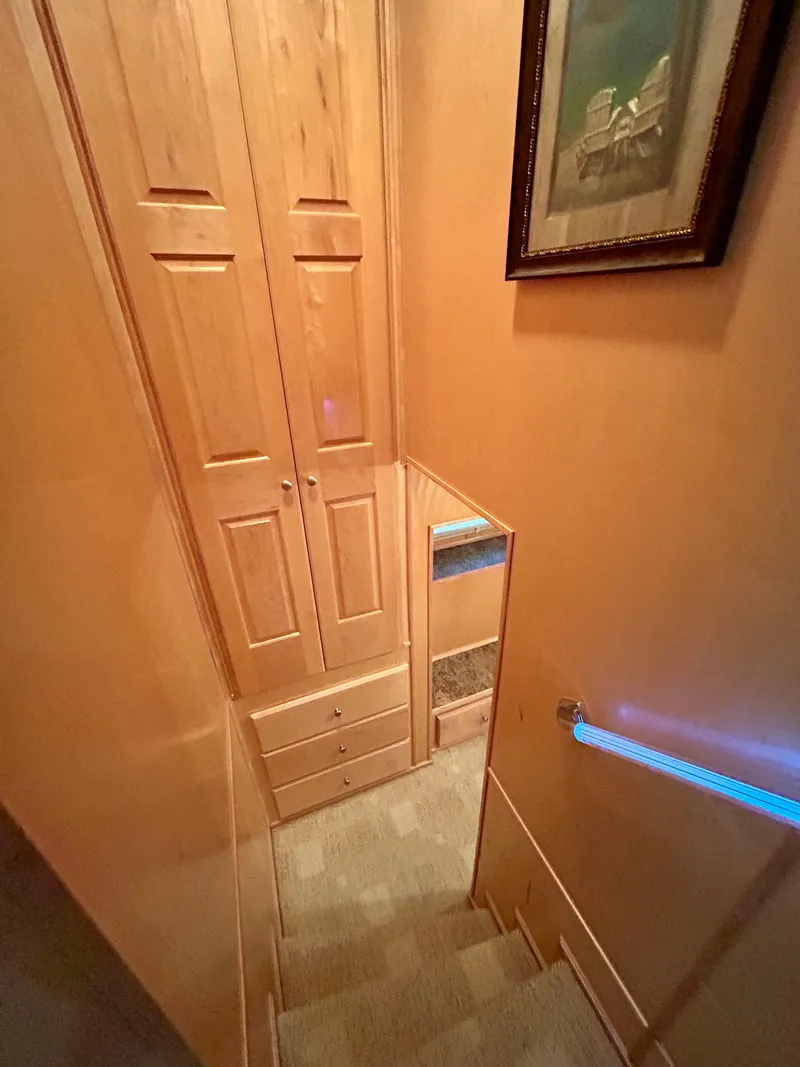 Slide: The Image of Staircase inside 2004 Horizon houseboat with wooden cabinets and framed artwork. - 21