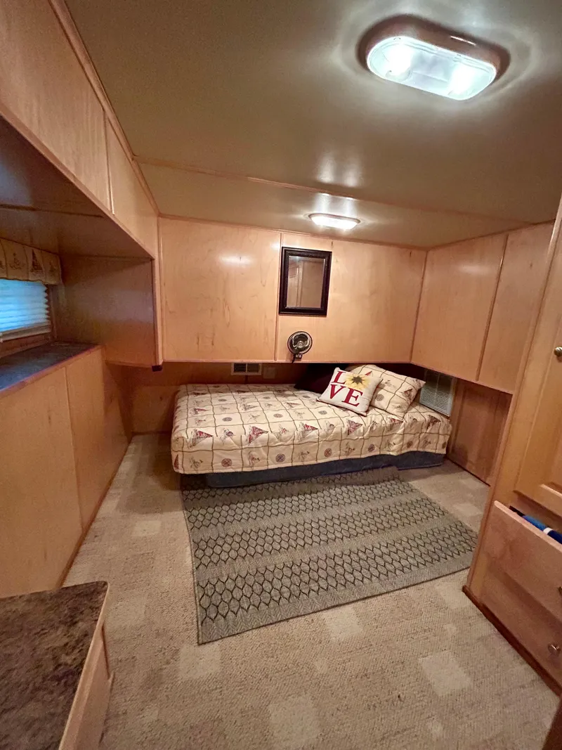 Slide: The Image of Cozy bedroom in 2004 Horizon houseboat with single bed and wooden interior. - 22
