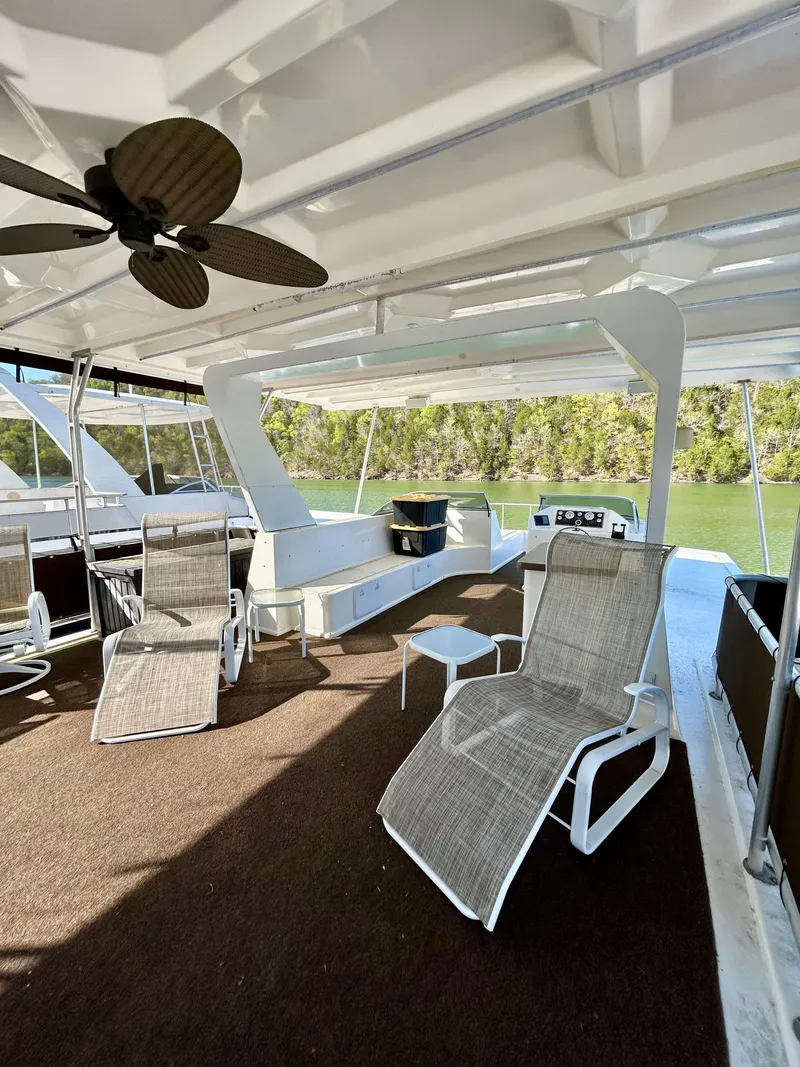 Slide: The Image of Spacious deck of a 2004 Horizon houseboat with lounge chairs and ceiling fan. - 25