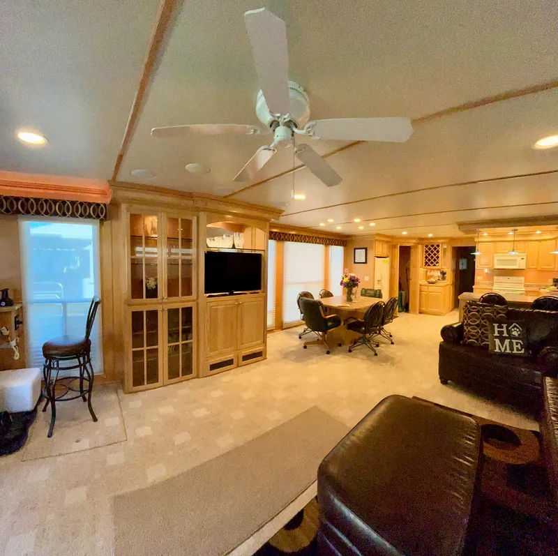 Slide: The Image of Spacious 2004 Horizon houseboat interior with cozy living area, dining table, and modern kitchen. - 4