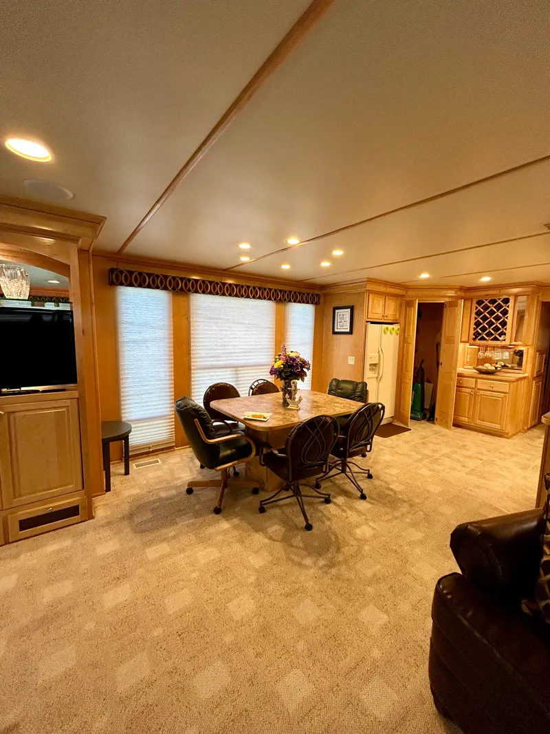 Slide: The Image of Luxurious 2004 Horizon houseboat interior with dining area, plush seating, and elegant wood cabinetry. - 7