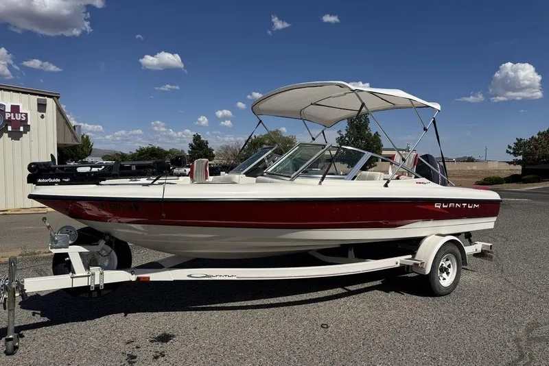 The Image of 1997 Bayliner Quantum 190 XFS boat on trailer, under clear blue sky. - 0
