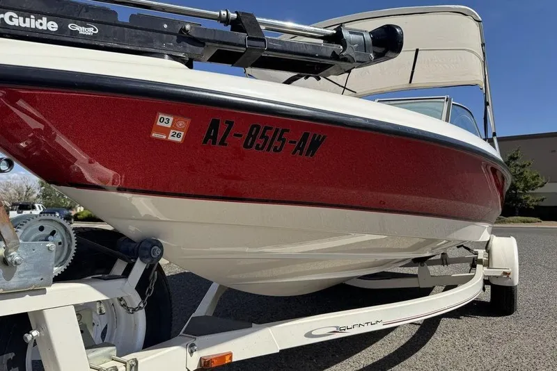 Slide: The Image of 1997 Bayliner Quantum 190 XFS boat on trailer, red and white exterior, registration visible. - 15