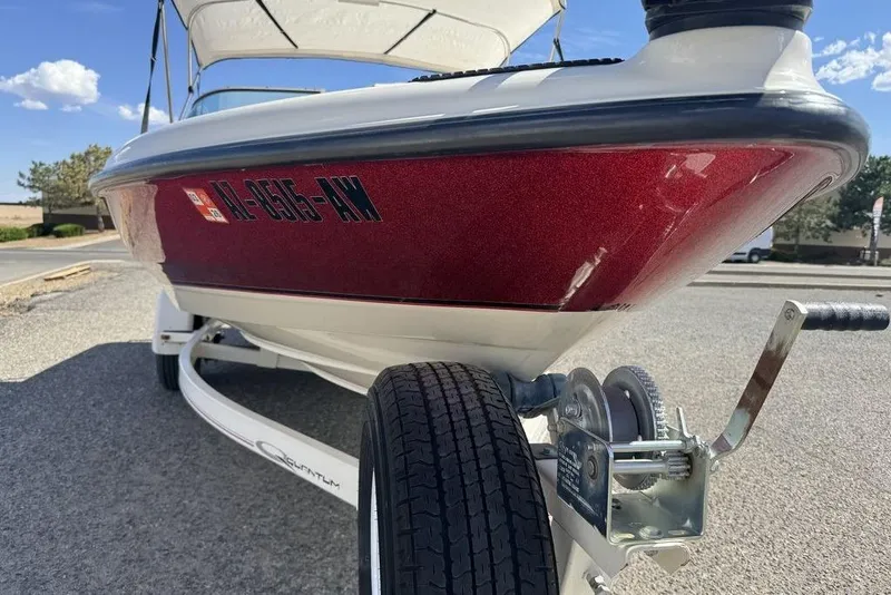 Slide: The Image of 1997 Bayliner Quantum 190 XFS boat on trailer, red and white hull, sunny day. - 18