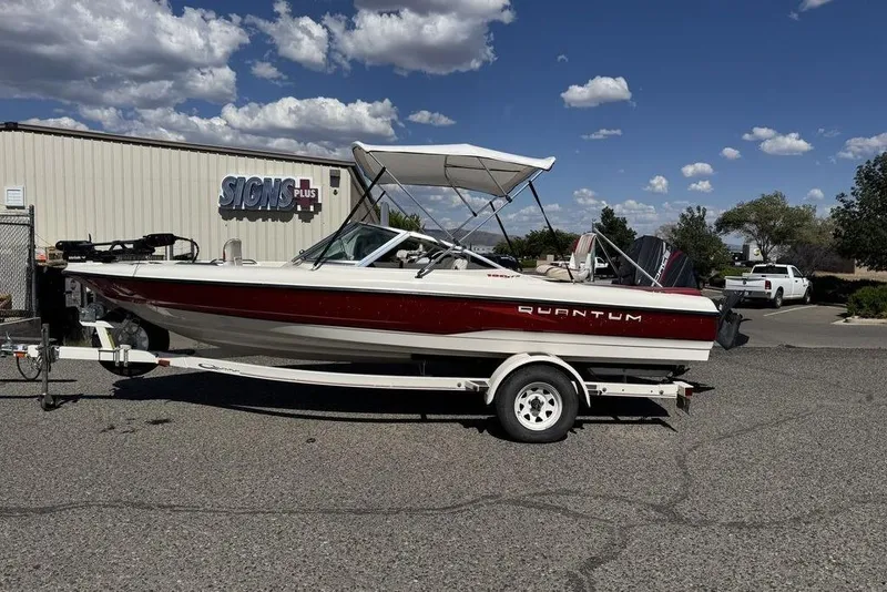 Slide: The Image of 1997 Bayliner Quantum 190 XFS boat on trailer, parked outdoors under a clear sky. - 2