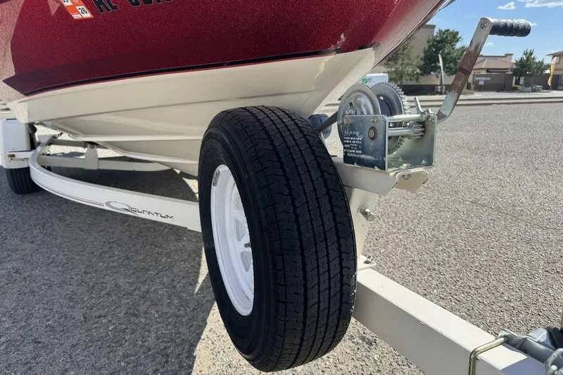 Slide: The Image of 1997 Bayliner Quantum 190 XFS boat trailer with wheel and winch on pavement. - 20