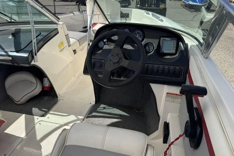 Slide: The Image of 1997 Bayliner Quantum 190 XFS boat interior with steering wheel and dashboard controls. - 22