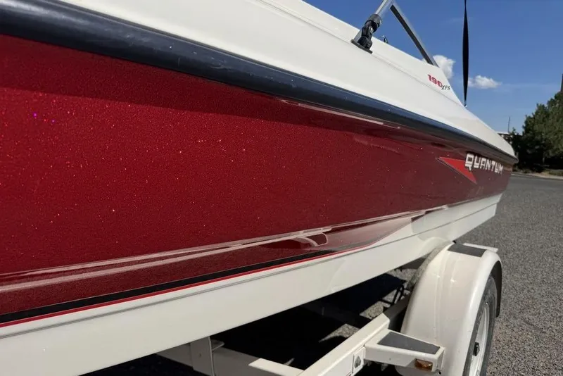 Slide: The Image of Red and white 1997 Bayliner Quantum 190 XFS boat on a trailer, side view. - 24