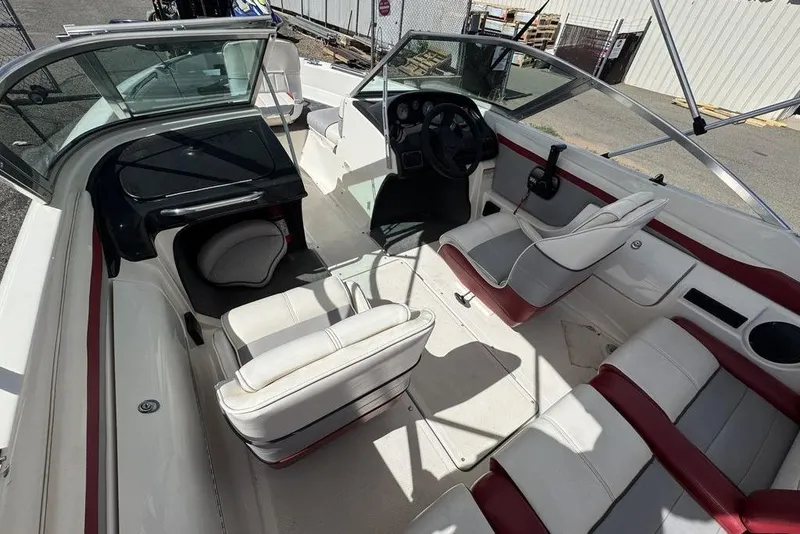 Slide: The Image of 1997 Bayliner Quantum 190 XFS boat interior with white and red seating, steering console, and open deck. - 26
