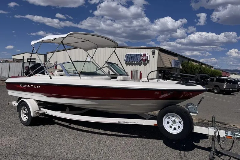 Slide: The Image of 1997 Bayliner Quantum 190 XFS boat on trailer, parked outside a building under a cloudy sky. - 37