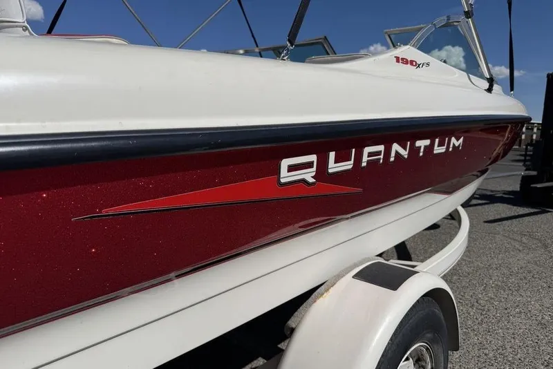 Slide: The Image of 1997 Bayliner Quantum 190 XFS boat with red and white exterior on a trailer. - 39