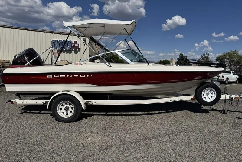 Slide: The Image of 1997 Bayliner Quantum 190 XFS boat on trailer, parked outdoors under a cloudy sky. - 40