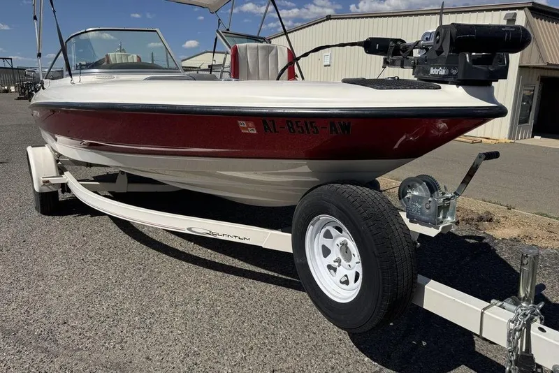 Slide: The Image of 1997 Bayliner Quantum 190 XFS boat on trailer, parked outdoors under clear sky. - 42