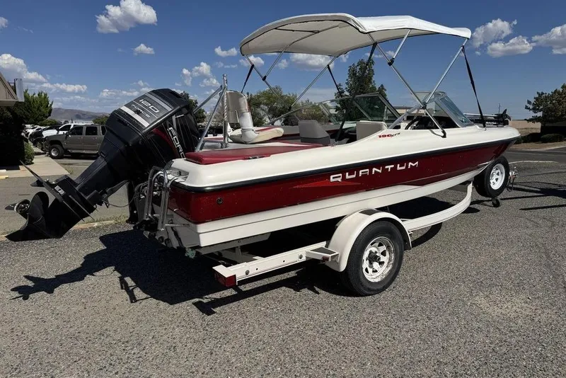 Slide: The Image of 1997 Bayliner Quantum 190 XFS boat on trailer, featuring outboard motor and canopy. - 43