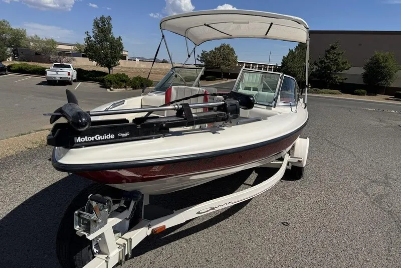 Slide: The Image of 1997 Bayliner Quantum 190 XFS boat with canopy on trailer in parking lot. - 9