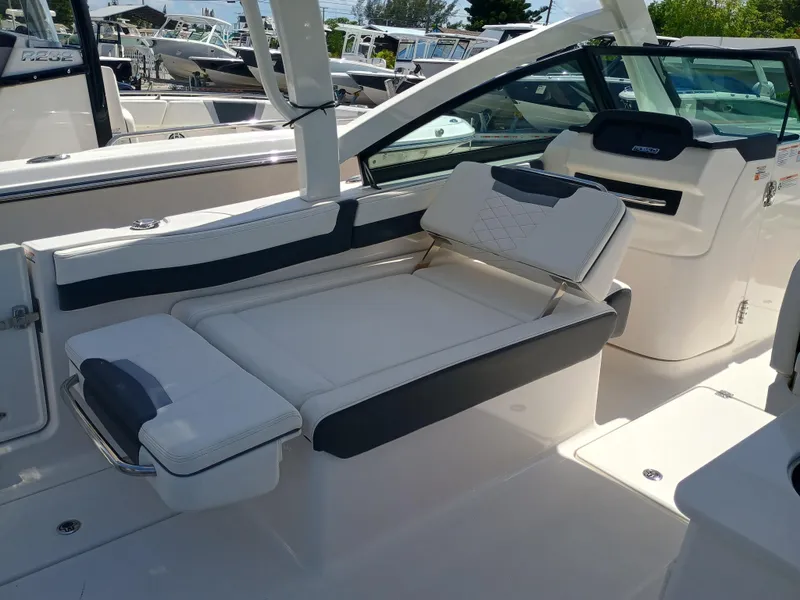 Slide: The Image of 2025 Robalo R257 Dual Console boat interior with white and gray seating. - 9