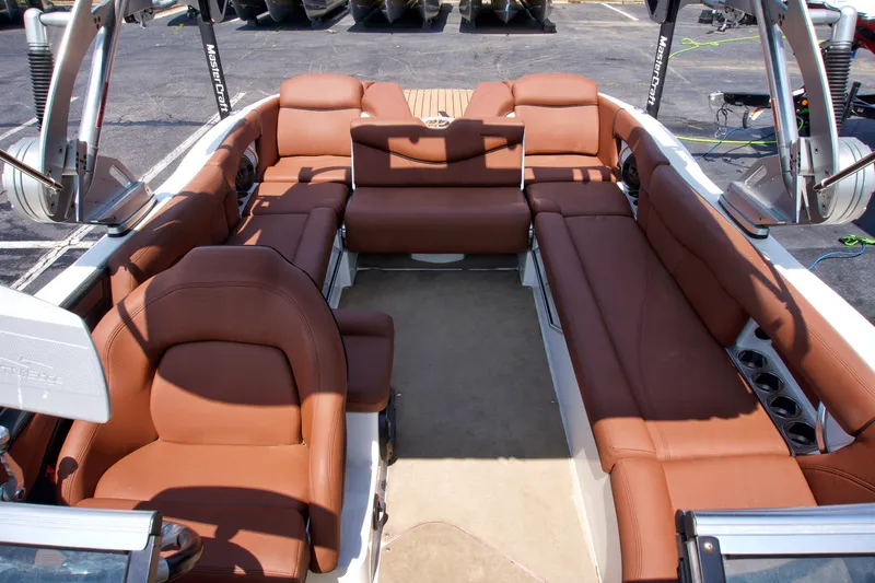 Slide: The Image of 2018 MasterCraft X46 boat interior with brown leather seating and spacious layout. - 10