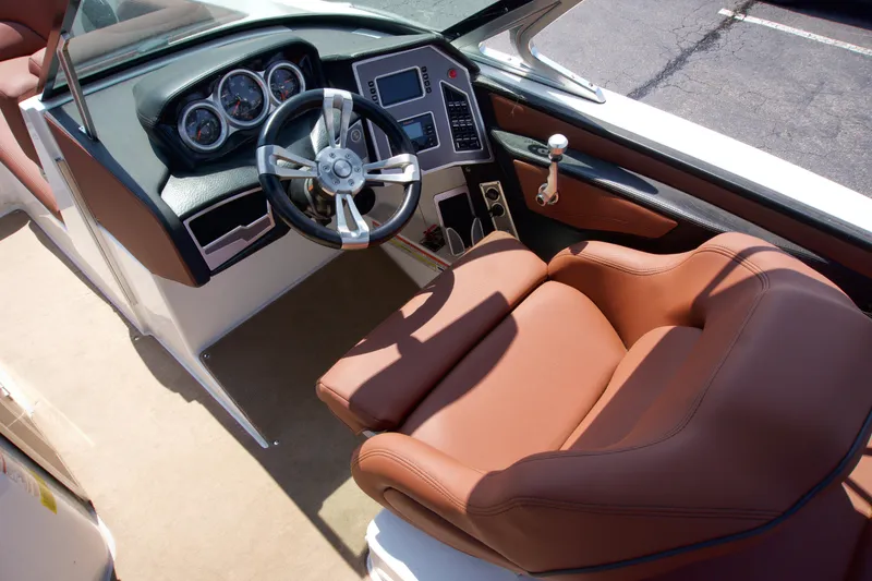 Slide: The Image of 2018 MasterCraft X46 boat interior with brown leather seats and modern dashboard. - 13
