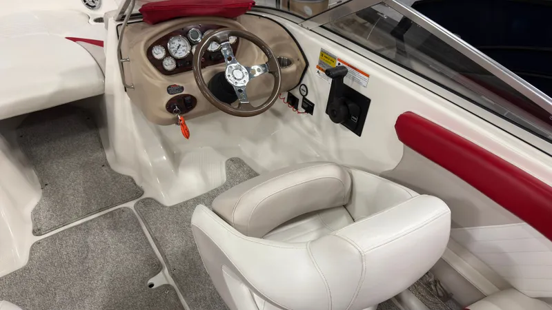 Slide: The Image of Interior of a 2008 Glastron GT 225 boat with steering console. - 10