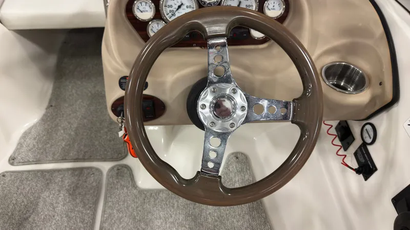 Slide: The Image of Steering wheel of a 2008 Glastron GT 225 boat with dashboard. - 11