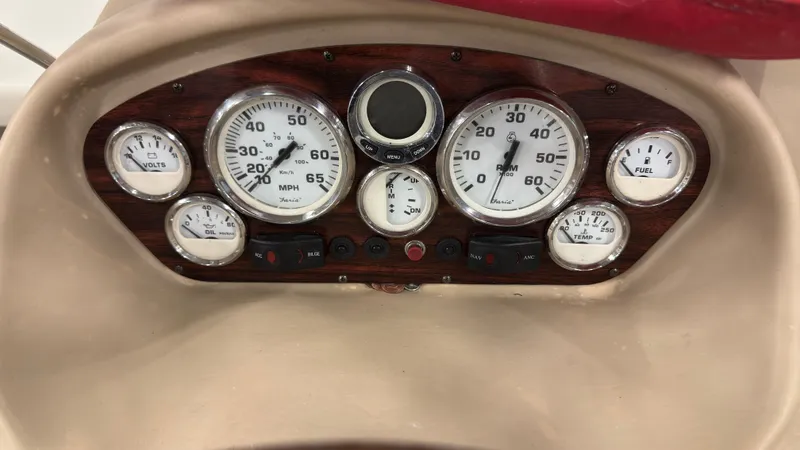 Slide: The Image of Dashboard of a 2008 Glastron GT 225 boat with speedometer and gauges. - 12