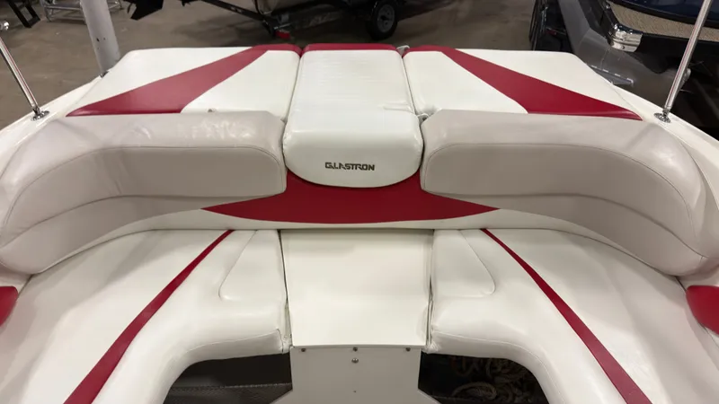 Slide: The Image of Interior of a 2008 Glastron GT 225 boat with red and white seating. - 6