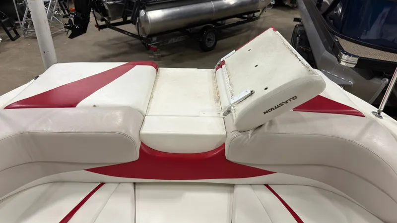 Slide: The Image of Interior of a 2008 Glastron GT 225 boat with red and white seating. - 7