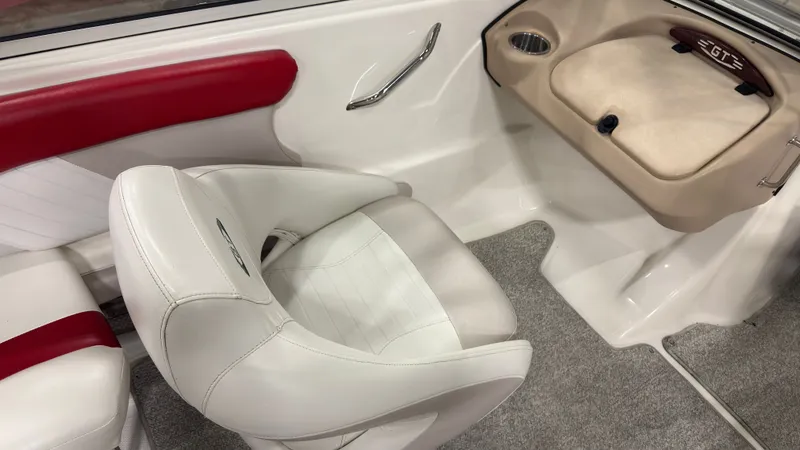 Slide: The Image of Interior of a 2008 Glastron GT 225 boat with white and red seating. - 9