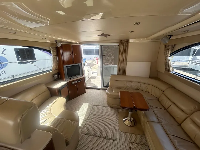 Slide: The Image of Luxurious interior of 2005 Meridian Gone Dingy 411 Sedan yacht with leather seating and TV. - 5