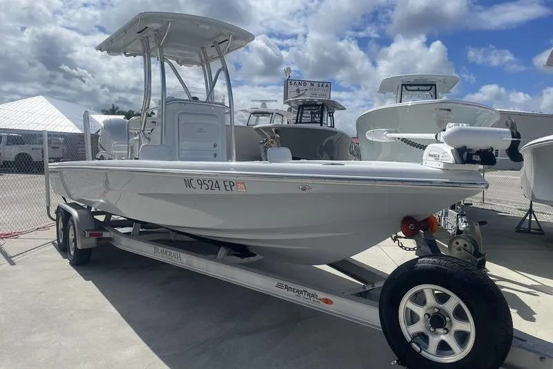 Slide: The Image of 2020 Islamorada Boatworks 24 Morada on trailer, displayed outdoors under cloudy sky. - 1