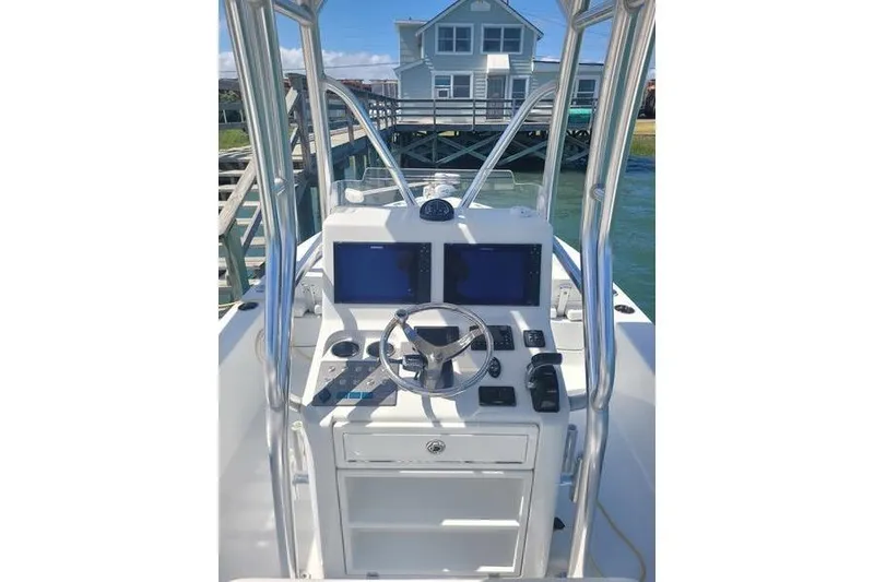 Slide: The Image of 2020 Islamorada Boatworks 24 Morada helm with dual screens and steering wheel. - 10