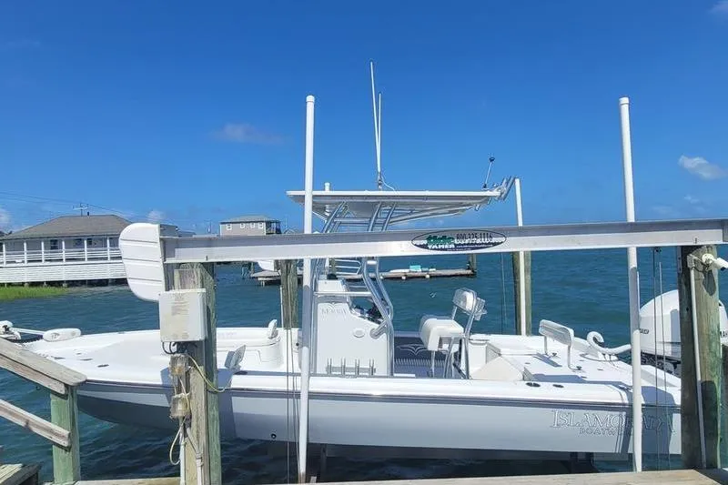 Slide: The Image of 2020 Islamorada Boatworks 24 Morada docked, clear blue sky, calm water. - 11