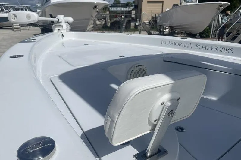 Slide: The Image of 2020 Islamorada Boatworks 24 Morada, white deck, sleek design, docked with other boats. - 14