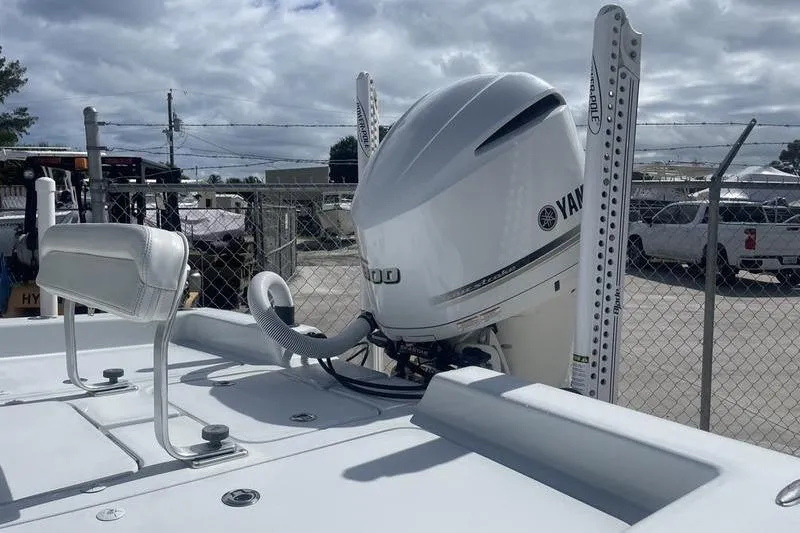 Slide: The Image of 2020 Islamorada Boatworks 24 Morada with Yamaha outboard motor, docked under cloudy skies. - 15