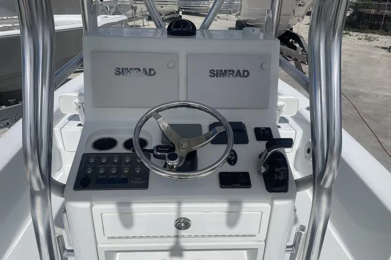 Slide: The Image of 2020 Islamorada Boatworks 24 Morada helm with Simrad electronics and stainless steel steering wheel. - 18