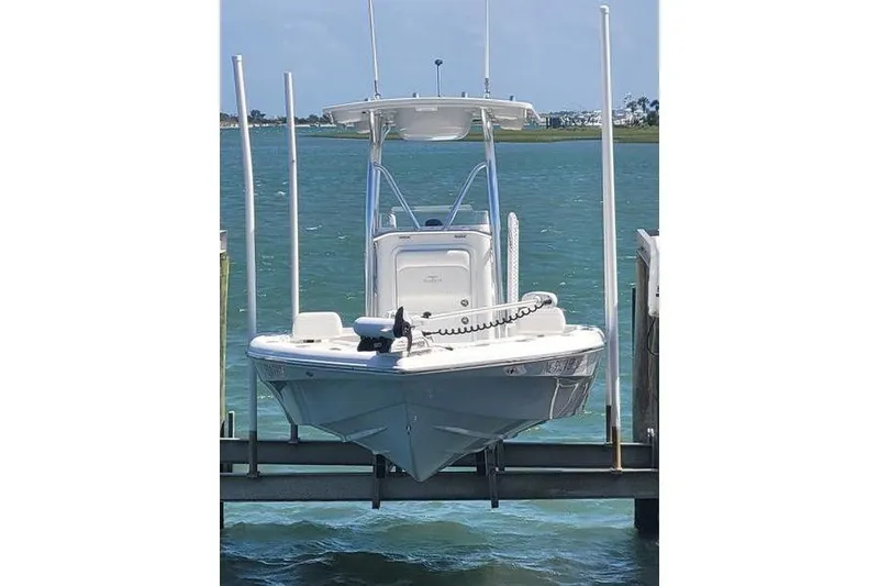 Slide: The Image of 2020 Islamorada Boatworks 24 Morada on lift, docked by the water. - 4
