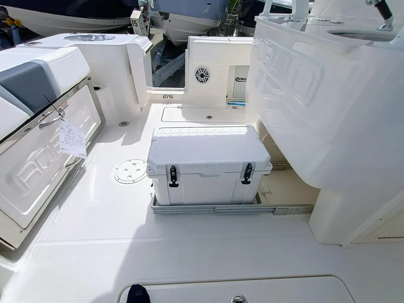 Slide: The Image of 2025 Robalo R270 Center Console boat interior with storage and cooler. - 12
