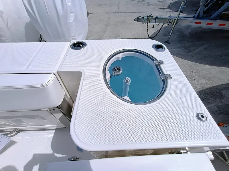 Slide: The Image of 2025 Robalo R270 Center Console boat with livewell and seating area. - 13